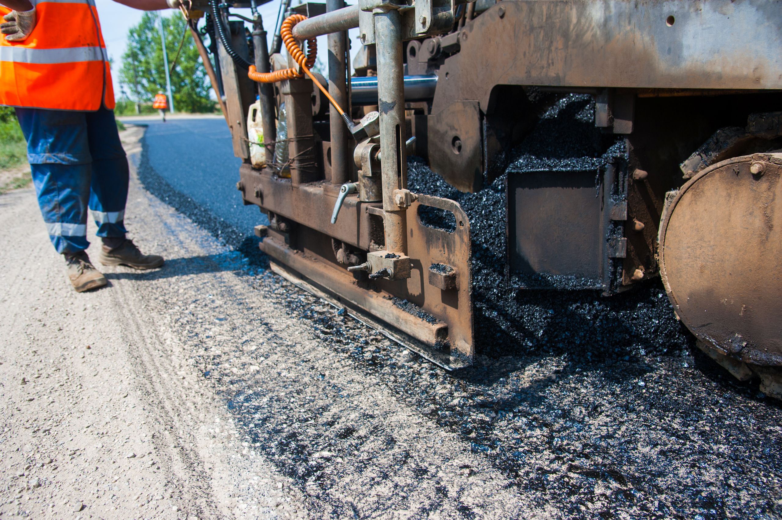 road-construction-asphalt-paver-laying-fresh-pavement-mill-overlay