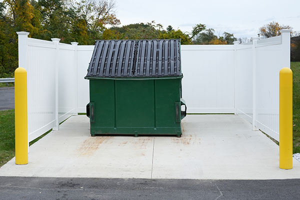 large green commercial dumpster for trash and recycling